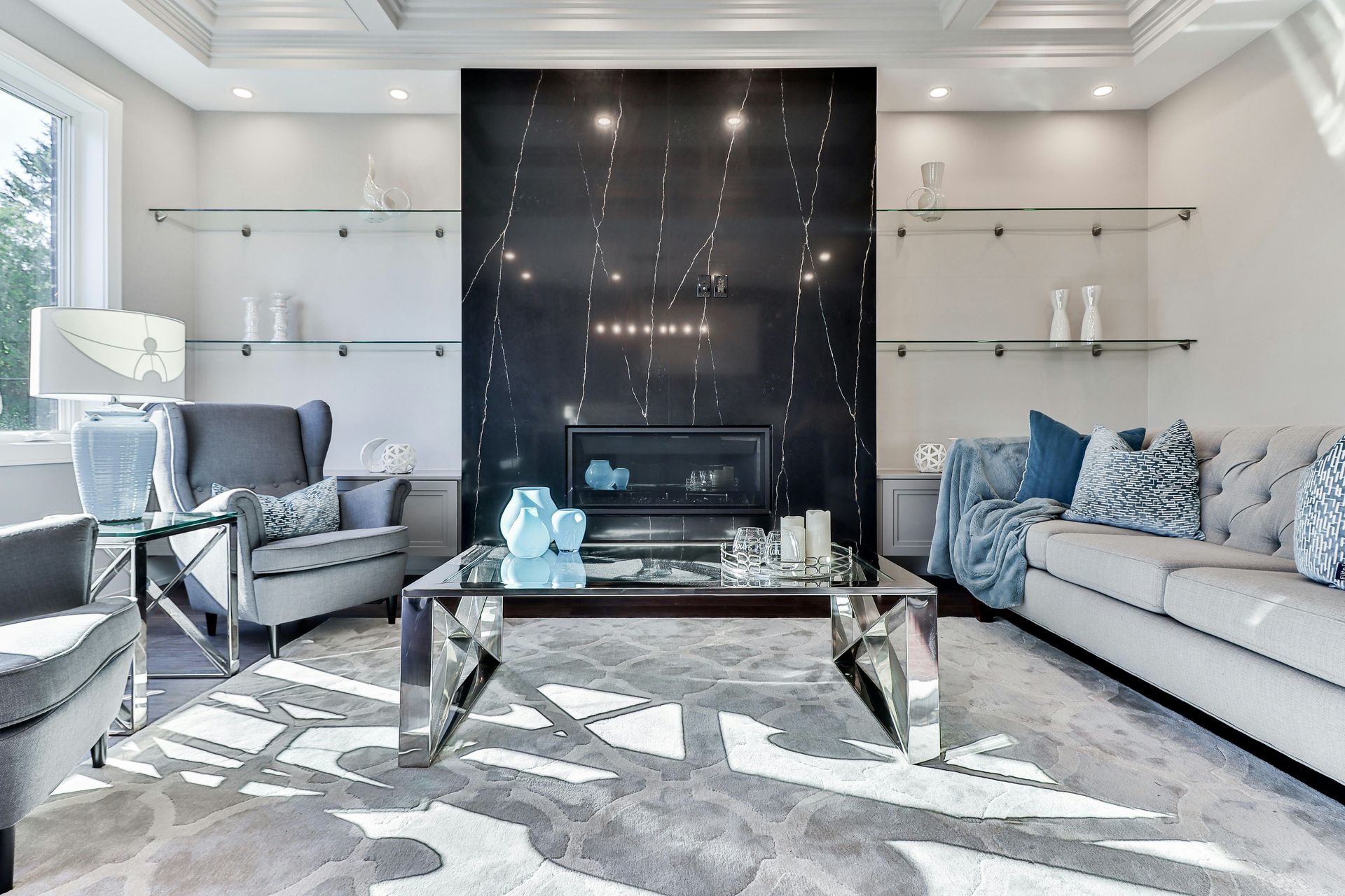 blue and white sofa near glass coffee table